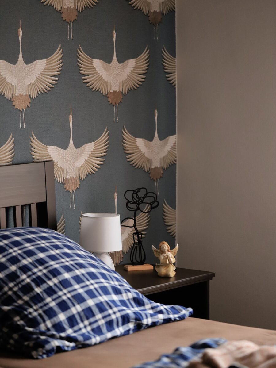 Bedroom with a decorative crane-motif wallpaper