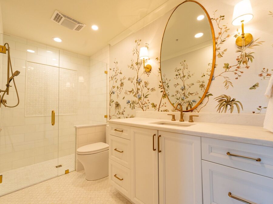 Elegant powder room with floral wallpaper and gold fixtures