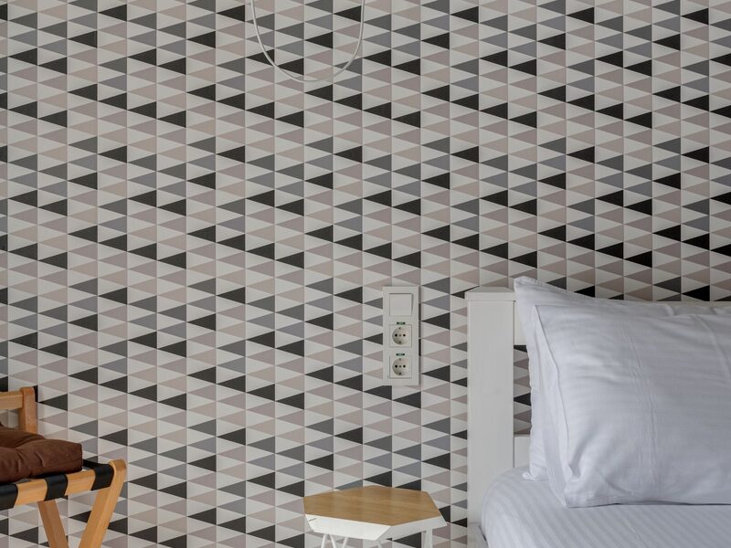 Bedroom fully finished with geometric patterned wallpaper