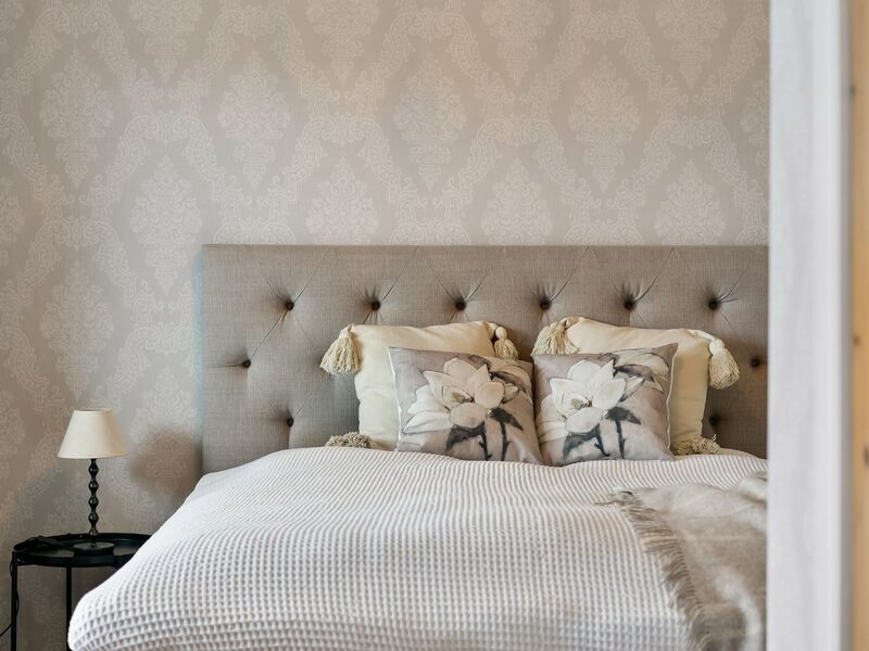 Neutral bedroom interior with softly textured wallpaper